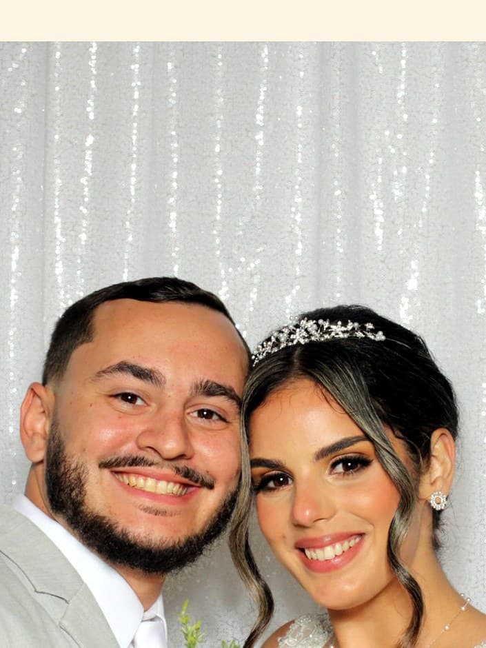 Bride and groom smiling together in the Picture Perfect Booths photo booth